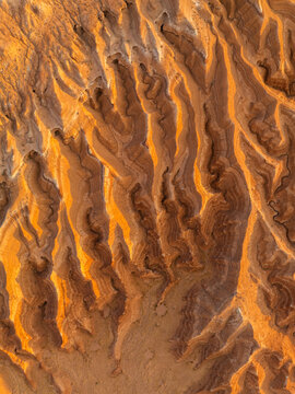 Aerial view of the unique orange rock formations and eroded sandstone layers in Goblin Valley State Park, Green River, Utah, United States.