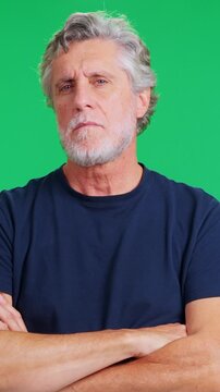 Mature caucasian man looking defiant on green screen