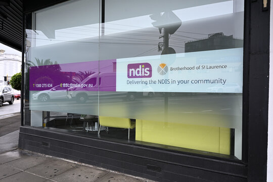 Window outside Stonnington Brotherhood of St Laurence NDIS local disability services office, featuring organisation logos