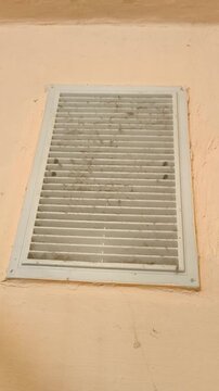 Ventilation grille on the wall with cobwebs in the bathroom. Hood, ventilation system in the house, bathroom