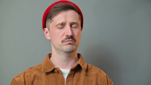 A man displays four distinct facial expressions that convey various emotions. The setup highlights emotional range in a simple format suitable for diverse commercial projects