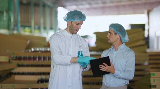 Quality control in process: Two professionals in protective gear engage in a detailed inspection and assessment within a manufacturing warehouse setting.