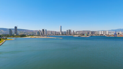 Fototapeta premium Izmir, Turkey.Panoramic aerial view of the Izmir bay and the modern city skyline with skyscrapers in Bayrakli district on a sunny summer day. Aerial view.
