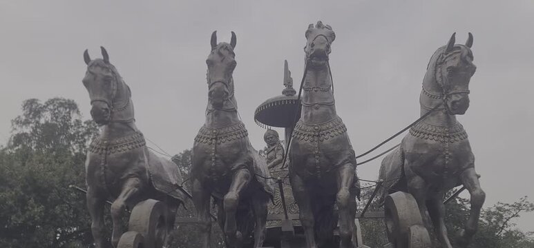 Magnificent Bronze Statue of Krishna and Arjuna Chariot During Rainy Weather in Kurukshetra India