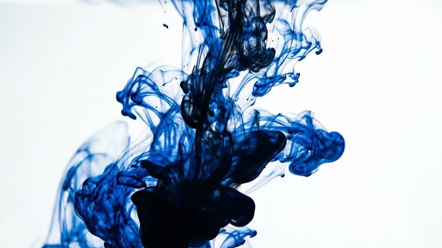 Deep blue ink swirls and dissolves into clear water creating abstract ethereal cloud like patterns a mesmerizing visual exploration of fluid dynamics and color