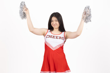 Obraz premium Happy cheerleader girl in red uniform holding silver pom poms