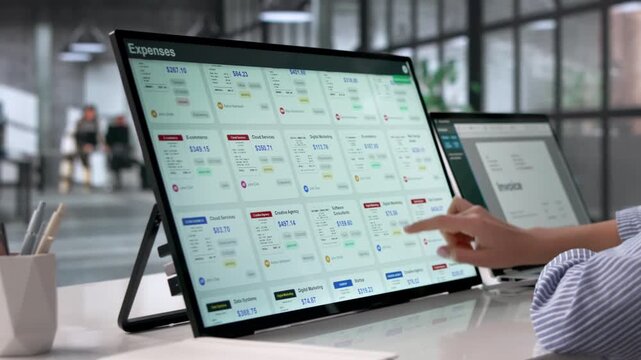 Finance Manager Reviewing Expense Reports On Laptop