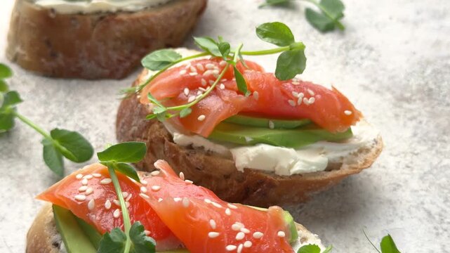 Healthy salmon avocado bruschetta appetizer rotating