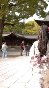 Two Women in Traditional Kimonos Walking Through Meiji Jingu Shrine in Tokyo