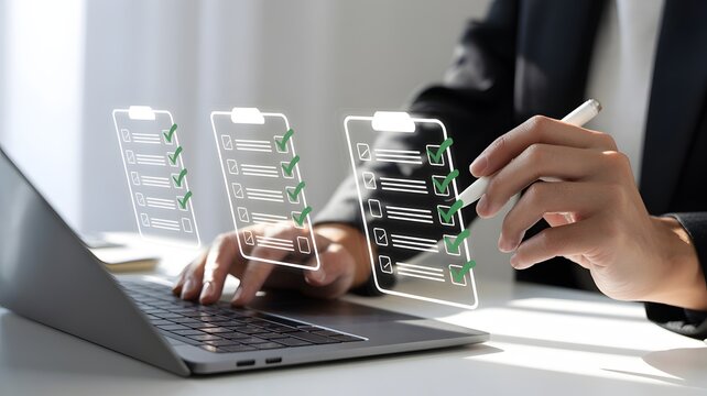 Businessperson reviewing checklists on a laptop with a pen in hand digitally enhanced.
