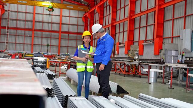 Team collaboration in industrial warehouse manufacturing facility training session indoor environment professional perspective