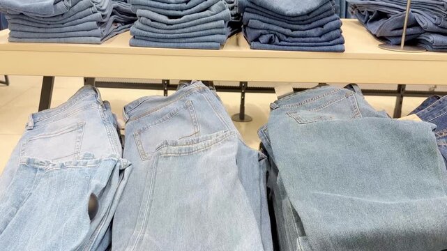 choosing clothes (jeans)in a shopping mall. clothes hangers	
