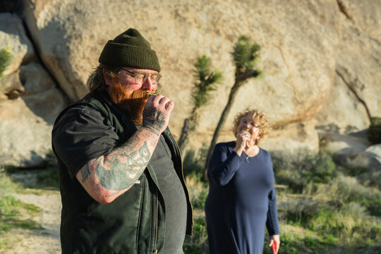 man and woman smelling sage in joshua tree