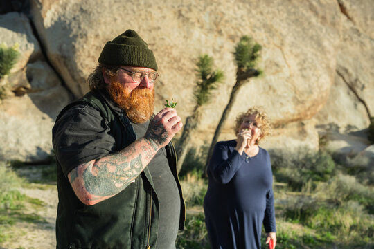 man and woman smelling sage in joshua tree