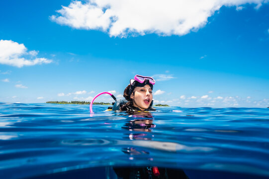 Diver surfacing after a dive in the southern Maldives