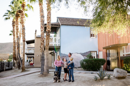 Family of Four & Dog Standing Outside Hotel in Borrego Springs, CA