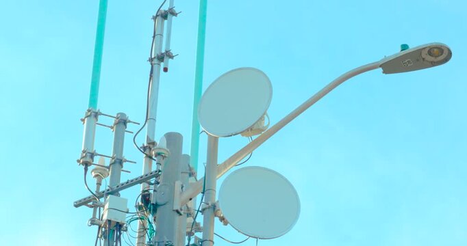 Close up of 5G small cell microwave dishes on urban utility pole