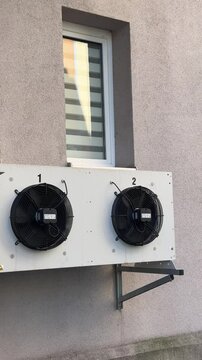 Electric air conditioning on a house with its fans vertical