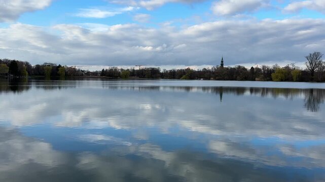 reflection of trees in water on the swan pond in zwickau east germany