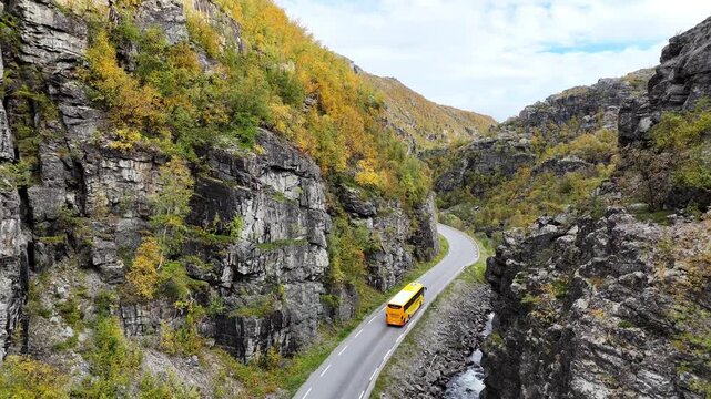 Aerial drone E45 highway with yellow Finnmark bus and car traffic