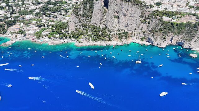 Captivating azure waters of Capri with boats navigating the stunning coastline under a clear blue sky
