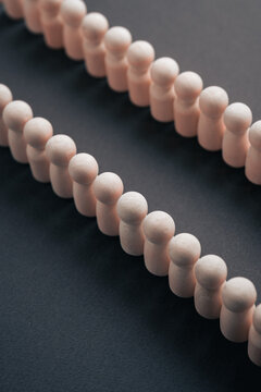 Wooden figurines in alignment as an abstract metaphor for structured communication and coordination.