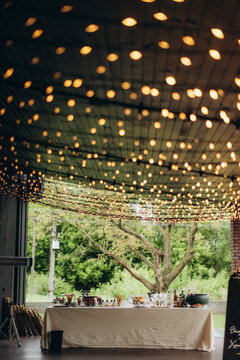Outdoor wedding reception bar with string lights