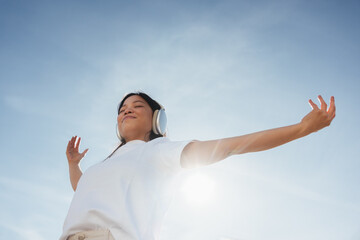 Woman with headphones enjoying outdoor music and relaxation © Jacob Lund