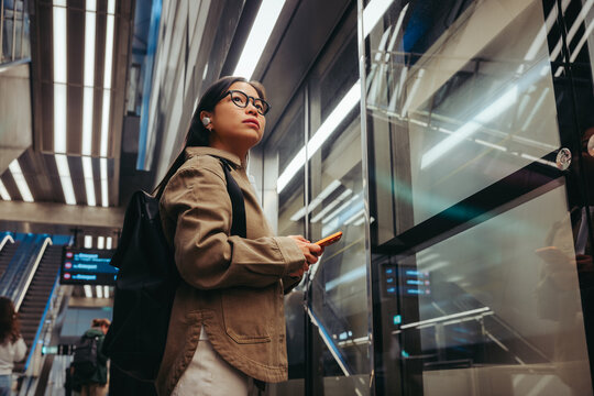 Commuter woman waiting at the station for the metro train