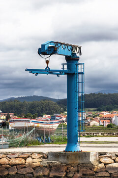 Blue harbor crane on a fishing shipyard dock