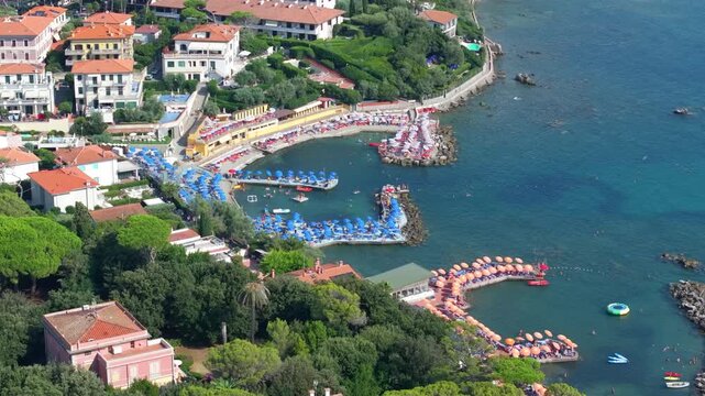 luxury vacationing on Tuscan seaside enclave of Castiglioncello, Italy, umbrellas, sun, European elegance and socializing on the beach