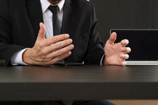 Businessman Gesturing During Meeting at Office Desk