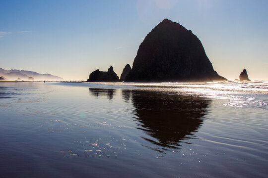 Haystack Rock in silhouette at sunset