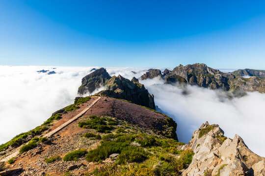 Hiking trail on Pico do Areeiro in Madeira above the clouds