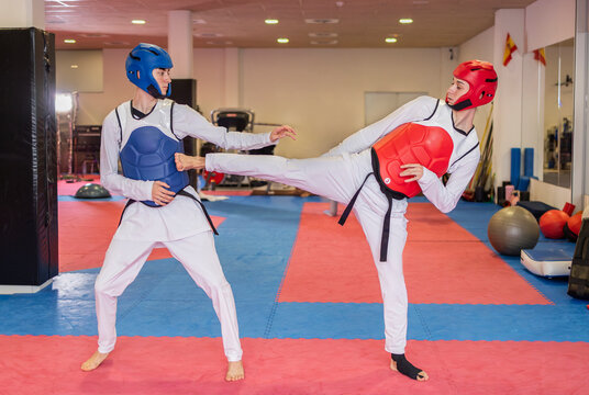 Young athletes practicing judo in a martial arts gym