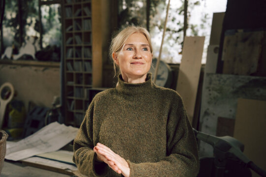 Mature woman in a workshop looking inspired and passionate