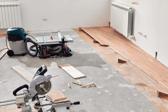 Assembling new laminate hardwood floor.