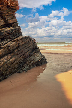 Beach Playa de Augas Santas (Beach of the Holy Waters, As Catedrais beach) during low tide at sunrise. Spain