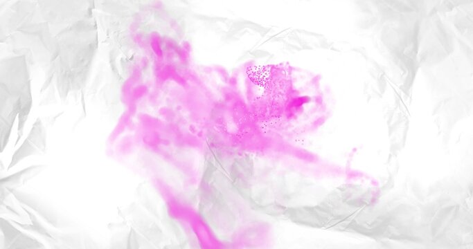 Swirling magenta pigment cloud drifting across crumpled white paper backdrop, speckles scattering