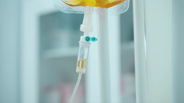 Yellow solution dripping in a drip in a medical office