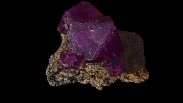 A purple amethyst crystal isolated on a black background
