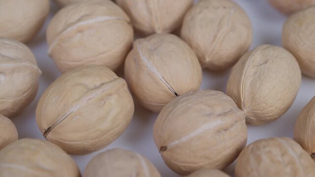 Macro photography capturing intricate details of walnut shells in natural light. Highquality closeup shot revealing delicate textures and patterns of walnuts in shells
