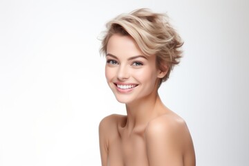 Fototapeta premium Woman with short blonde hair and natural makeup looking at camera