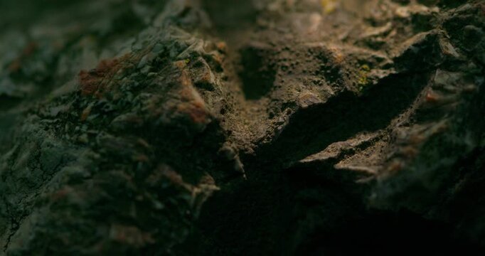 Close-up rugged rock surface with natural texture and shadows