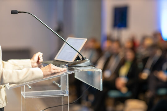 Female public speaker at business conference, corporate presentation, workshop, coaching training, news conference, company meeting, public or political event. Public speaking concept.