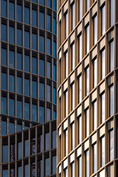 Abstract architecture detail with golden facade and modern windows where curve geometry forms a grid pattern on contemporary urban office tower