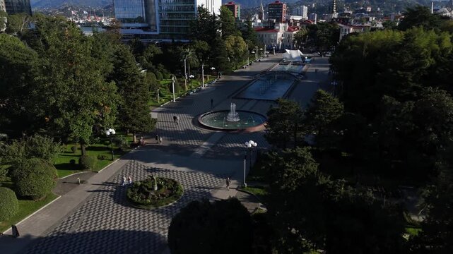 Drone view focusing on the decorative water fountain located on the seaside boulevard in Batumi, Georgia.