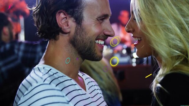 Music pulsing couple leaning, flirting in club, striped tee, choker under neon lights