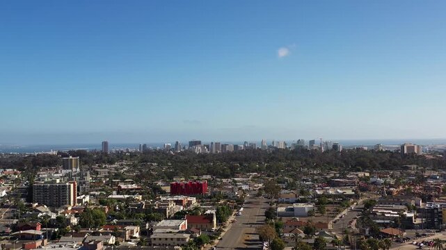 Drone flying toward downtown San Diego from North Park at 5PM capturing a wide shot of the city skyline and surrounding neighborhoods.