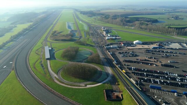 Aerial drone shot of a massive automotive proving ground and vehicle testing track on a frosty winter morning